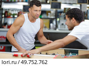two men playing table football. Стоковое фото, агентство Ingram Publishing / Фотобанк Лори