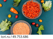 Uncooked Vegan Pasta, Red Lentil fusilli on the plate.. Dried orange spiral noodles. Стоковое фото, агентство Ingram Publishing / Фотобанк Лори