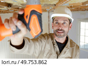male holds a drill indoors. Стоковое фото, агентство Ingram Publishing / Фотобанк Лори