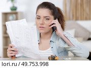 woman asks for help while assembling a furniture. Стоковое фото, агентство Ingram Publishing / Фотобанк Лори