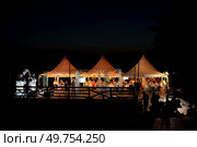 celebration in a night tent on the shore. Стоковое фото, агентство Ingram Publishing / Фотобанк Лори