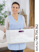 happy worker with folded towels after laundry. Стоковое фото, агентство Ingram Publishing / Фотобанк Лори