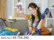 happy woman rpacking suitcase for vacation. Стоковое фото, агентство Ingram Publishing / Фотобанк Лори