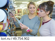 young women customer buying something in textile department. Стоковое фото, агентство Ingram Publishing / Фотобанк Лори