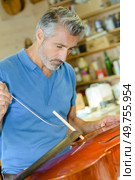portrait of man mending a cello. Стоковое фото, агентство Ingram Publishing / Фотобанк Лори
