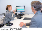 Woman moving computer to show display to clients. Стоковое фото, агентство Ingram Publishing / Фотобанк Лори