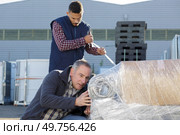 men working outdoors a factory. Стоковое фото, агентство Ingram Publishing / Фотобанк Лори