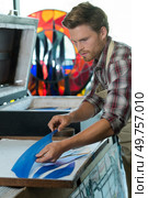 man working on industrial injection molding press machine. Стоковое фото, агентство Ingram Publishing / Фотобанк Лори