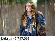 On this sunny day, a young woman with long hair enjoys a serene setting, dressed in a stylish outfit that reflects her cheerful demeanor and passion for beauty, making the moment delightful. A Joyful Young Woman with a Bright Smile Enjoying Nature in Her Casual Outfit with Long Hair. Стоковое фото, агентство Ingram Publishing / Фотобанк Лори