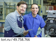 woman and man manufacturing worker posing in factory. Стоковое фото, агентство Ingram Publishing / Фотобанк Лори