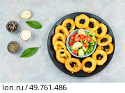 Rings of squid in batter with sauce. Top view.. Fried calamari squid appetizer. Стоковое фото, агентство Ingram Publishing / Фотобанк Лори