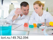 a team of lab chemists checking solutions. Стоковое фото, агентство Ingram Publishing / Фотобанк Лори