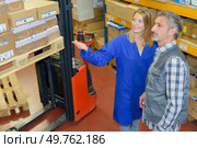factory workers in the process of working on the equipment. Стоковое фото, агентство Ingram Publishing / Фотобанк Лори