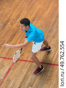high angle view of young male teenager playing indoor tennis. Стоковое фото, агентство Ingram Publishing / Фотобанк Лори