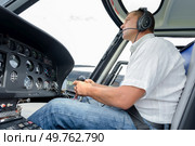 pilot in cockpit of helicopter during flight. Стоковое фото, агентство Ingram Publishing / Фотобанк Лори