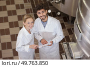 brewer and couple in beer brewery guided tour. Стоковое фото, агентство Ingram Publishing / Фотобанк Лори