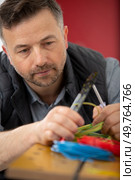 man holding side cutting pillers and conductors. Стоковое фото, агентство Ingram Publishing / Фотобанк Лори