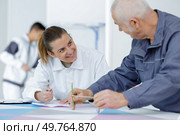 male and female civil engineers checking office blueprints. Стоковое фото, агентство Ingram Publishing / Фотобанк Лори