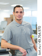 happy worker standing in factory. Стоковое фото, агентство Ingram Publishing / Фотобанк Лори