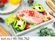 Raw sliced pork loin with spices and herbs. Schnitzel, steak or meat tenderloin.. Fresh tasty raw meat pieces. Стоковое фото, агентство Ingram Publishing / Фотобанк Лори