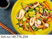 Fresh and healthy salad Asian seafood squid and vegetables.. Spicy squid vegetables with in plate on table. Стоковое фото, агентство Ingram Publishing / Фотобанк Лори