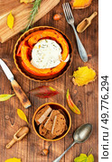 Baked pumpkin with camembert cheese. Rustic background of baked pumpkin. Dietary food.. Pumpkin stuffed filled with camembert cheese. Стоковое фото, агентство Ingram Publishing / Фотобанк Лори