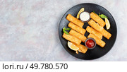 Prepared crumbed fried fish fingers in sticks with sauce. Space for text.. Fish finger or stick or nuggets. Стоковое фото, агентство Ingram Publishing / Фотобанк Лори