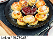 Syrniki, cottage cheese fritters with strawberry jam on a plate.. Cottage cheese pancakes or curd fritters stack. Стоковое фото, агентство Ingram Publishing / Фотобанк Лори