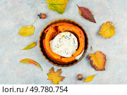 Halved orange pumpkin, baking. Pumpkin or squash baked with camembert.. Roasted pumpkins and autumn leaves. Стоковое фото, агентство Ingram Publishing / Фотобанк Лори