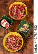 Salad of sprouted alfalfa, beans, red radish with pomegranate seeds and black carrots on wooden rustic background.. Sprouts and pomegranate salad. Стоковое фото, агентство Ingram Publishing / Фотобанк Лори