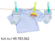 blue and pink baby clothes hanging on rope isolated on white. baby socks. Стоковое фото, агентство Ingram Publishing / Фотобанк Лори