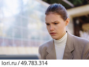 A young woman dressed in a contemporary and stylish outfit stands alone in a bustling urban environment while appearing pensive, lost in her deep thoughts amid a calm and serene backdrop. A contemplative woman is captured in an urban environment, showcasing her depth and beauty. Стоковое фото, агентство Ingram Publishing / Фотобанк Лори
