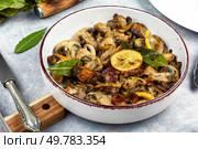 Delicious fried champignon mushrooms with bay leaf, spices and lemon.. Fried champignon mushrooms. Стоковое фото, агентство Ingram Publishing / Фотобанк Лори