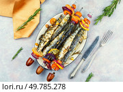 Fish kebabs, sardines on skewer, barbecue grill. Grilled sardines with vegetables. Top view.. Baked sardines skewers. Стоковое фото, агентство Ingram Publishing / Фотобанк Лори