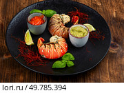 Juicy lobster tail with lime and saffron, luxurious seafood dish. Luxury seafood.. Preparing lobster tails. Стоковое фото, агентство Ingram Publishing / Фотобанк Лори