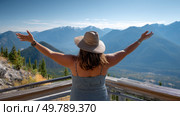 A plus-size woman enjoying a scenic view at a mountain lookout, feeling grateful for the journey. Стоковое AI-изображение, AI-художник ALLA YURTAYEVA / Фотобанк Лори