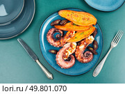 Delicious grilled octopus served with aromatic sweet potato or yam. Fried octopus. Flat lay. Summer barbecue with octopus. Стоковое фото, агентство Ingram Publishing / Фотобанк Лори