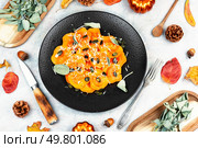 Cooked ravioli with pumpkin and sage leaves on a plate. Flat lay.. Plate of pumpkin ravioli with sage leaves. Стоковое фото, агентство Ingram Publishing / Фотобанк Лори
