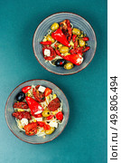 A delicious salad of pickled soybean sprouts, dried tomatoes, olives and peppers. Chinese food.. Vegan Salad of Pickled Vegetables and Soybeans. Стоковое фото, агентство Ingram Publishing / Фотобанк Лори