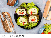 Funny monster face on Halloween sandwich toast. Halloween. Flat lay. Mini sandwiches with monster faces. Стоковое фото, агентство Ingram Publishing / Фотобанк Лори