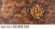 Mussels in cream sauce with tomatoes and garlic on rustic wooden table. Copy space.. Plate of mussels on a table. Стоковое фото, агентство Ingram Publishing / Фотобанк Лори