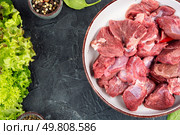 Raw venison or deer meat, exotic gourmet meat. Space for text.. Raw deer venison prepared for a cooking process. Стоковое фото, агентство Ingram Publishing / Фотобанк Лори
