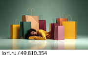 Overconsumption represented as a person drowning in shopping bag. Symbol of a major environmental problem caused by urban overconsumption waste. Abstract image. Стоковое AI-изображение, AI-художник ALLA YURTAYEVA / Фотобанк Лори