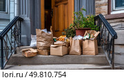 A food delivery pile-up at an apartment door. Symbol of a major environmental problem caused by urban overconsumption waste. Abstract image. Стоковое AI-изображение, AI-художник ALLA YURTAYEVA / Фотобанк Лори
