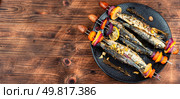 Grilled sardines fried on skewers, fish kebab or shashlik. Space for text.. Grilled sardines, shashlik. Стоковое фото, агентство Ingram Publishing / Фотобанк Лори