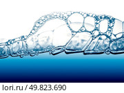 Air bubbles in blue water on white background. Стоковое фото, агентство Ingram Publishing / Фотобанк Лори
