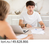 Guy manager tells woman client about specifics of design of microloan, about benefits and advantages. Стоковое фото, фотограф Яков Филимонов / Фотобанк Лори
