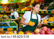 Portrait of woman marketer working at fruit department of store. Стоковое фото, фотограф Яков Филимонов / Фотобанк Лори