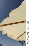 Yellow and white striped beach umbrella summer vacation sun protection outdoor shade parasol poolside canopy.Pink beach umbrella and striped chair by the ocean. Стоковое видео, видеограф Zita Khasanova / Фотобанк Лори
