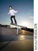 Skateboarder on a grind at the local skatepark. Стоковое фото, агентство Ingram Publishing / Фотобанк Лори